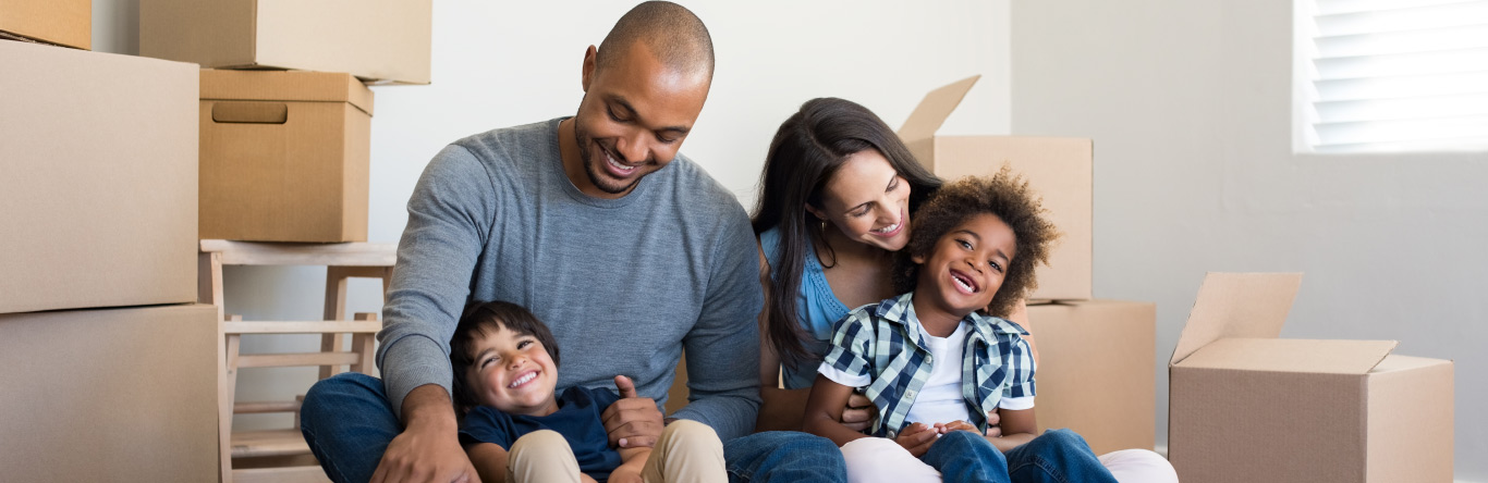 Young family with moving boxes